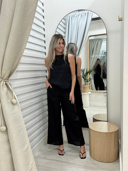 The Atlas Linen Top in Black shown on our Wanted and Wild Model in our changerooms. Shown with our Atlas Linen Pintuck Pants