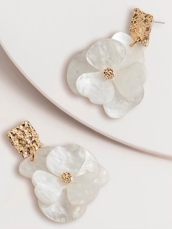 The Dahlia Earrings are a pair of floral earrings with gold accents on a white surface. Super Amazing at Wanted and Wild