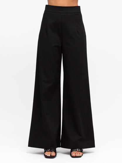 Front view of the luxe suit pants in black by White closet at Wanted and Wild.