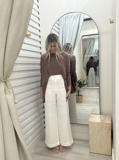 Mia oversized knit jumper in chocolate brown, worn with luxe linen pants in white at Wanted and Wild.