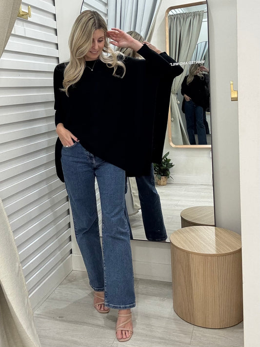 Woman in Mia Oversized Knit in Black and blue jeans, great basics at Wanted and wild.